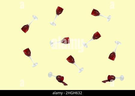 Trendy dishes pattern made with wine glasses. Several wine glasses on a light yellow background. Stock Photo