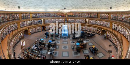 Stockholm, Sweden, January 18, 2022: Interiour of the famous public library stadsbiblioteket in Stockholm, architect Gunnar Asplund with many books on Stock Photo