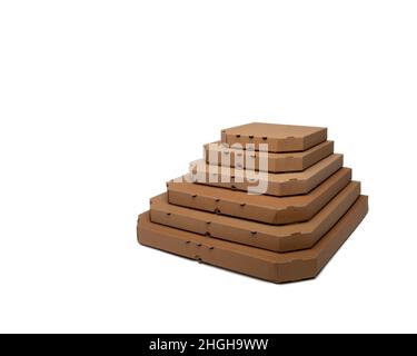 Many stacked carton pizza boxes of different sizes, restaurant delivery packging concept. White background, mock up copy space Stock Photo