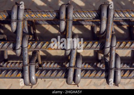 Assembly of reinforcing bars for pouring concrete. Industrial background. Rebar texture Steel rebar for reinforcement concrete at construction site. Stock Photo