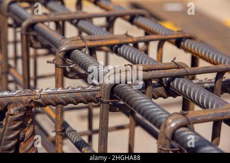 Assembly of reinforcing bars for pouring concrete. Industrial background. Rebar texture Steel rebar for reinforcement concrete at construction site. Stock Photo