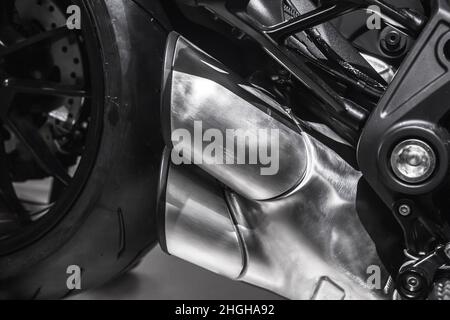 Sports motorcycle engine fragment with exhaust pipes, close up photo, gray metal parts Stock Photo