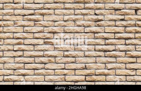 Seamless background texture of decorative yellow brick wall, front view Stock Photo