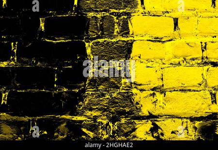 Yellow painted dark brick wall surface with grunge texture for background Stock Photo