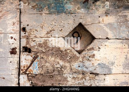 Weathered painted and peeling door wuth the number nine painted on Stock Photo