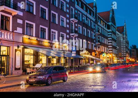 Riga, Latvia. Parked Cars On Kalku Street In Evening Or Night Illumination In Old Town Stock Photo