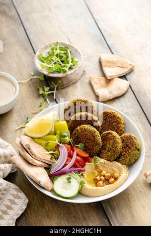 Baked falafel bowl with hummus and vegetables Stock Photo