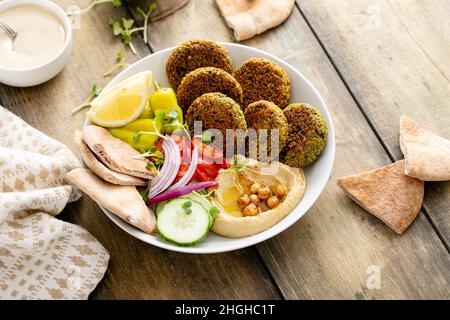 Baked falafel bowl with hummus and vegetables Stock Photo