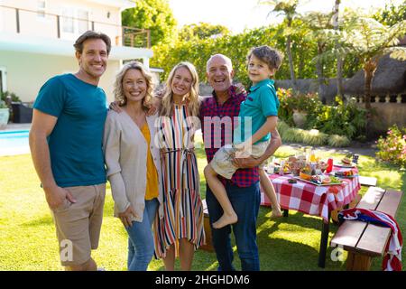 Portrait of smiling three generational caucasian family standing together in garden Stock Photo
