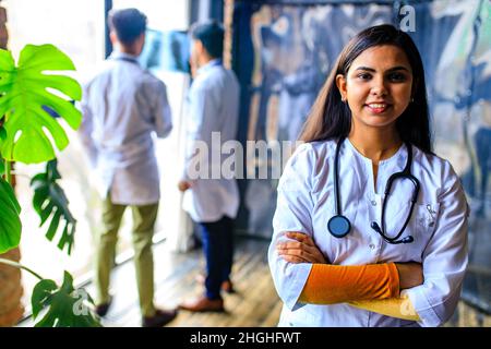 Mixed race Asian doctors and nurse at the office Stock Photo