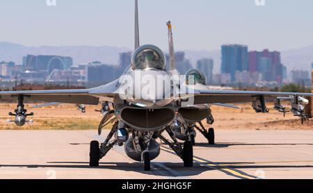 A pair of F-16 Fighting Falcon fighter jets taxi prior to taking-off for a Red Flag 21-3 mission at Nellis Air Force Base, Nevada, Aug. 2, 2021. Red Flag takes place over the Nevada Test and Training Range and provides the warfighter a flexible, realistic and multi-dimensional battle space to conduct advanced training of U.S. military services and coalition forces. Stock Photo