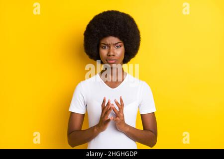 Photo of unhappy young afro american woman evil plan hold hands isolated on shine yellow color background Stock Photo