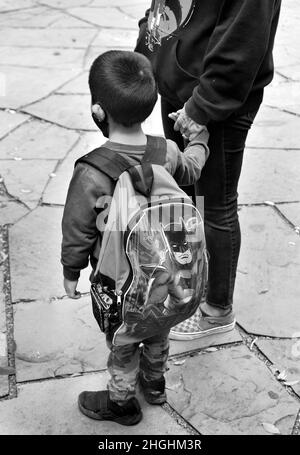 A Native American woman holds hands with her young son at an Indigenous Peoples' Day celebration in Santa Fe, New Mexico Stock Photo