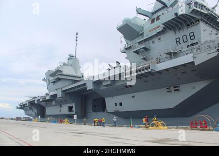 SANTA RITA, Guam (Aug. 6, 2021) - HMS Queen Elizabeth pulled into Apra Harbor as part of the United Kingdom Carrier Strike Group (CSG) 21 deployment to the Indo-Pacific Region. Local media representatives were invited onboard the ship for a press conference with CSG21 Commodore Steve Moorhouse, U.S. Naval Base Guam Commanding Officer Capt. Michael Luckett, Guam Governor Lourdes Leon Guerrero and Lt. Governor Josh Tenorio.     HMS Queen Elizabeth is the largest and most powerful vessel ever constructed for the Royal Navy and is capable of carrying up to 40 aircraft. Aside from its state-of-the- Stock Photo