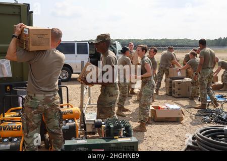 CAMP RIPLEY, Minn. - V Corps Soldiers pack military field rations, known as MREs or meals ready to eat, and other mission essentials into a CONEX box during V Corps third command post exercise at Camp Ripley, Minnesota, Aug. 6. V Corps conducted CPX3 in preparation for the upcoming warfighter culminating training event, that once successfully completed, will certify the corps headquarters’ ability to take responsibility for mission assumption. Stock Photo