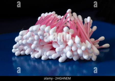 Hygienic cotton swabs on a blue table. Medical items on a black background Stock Photo