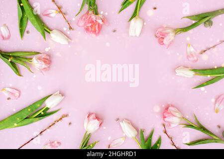Creative layout made of colorful spring flowers and green leaves. Minimal holiday concept. Flat lay pattern. Stock Photo