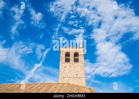 Tower of the church against cloudy sky. Zarzuela del Monte, Segovia province, Castilla Leon, Spain. Stock Photo