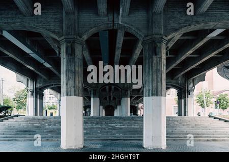 Old stone bridge structure from below in Bilbao city. Cold blue effect applied Stock Photo