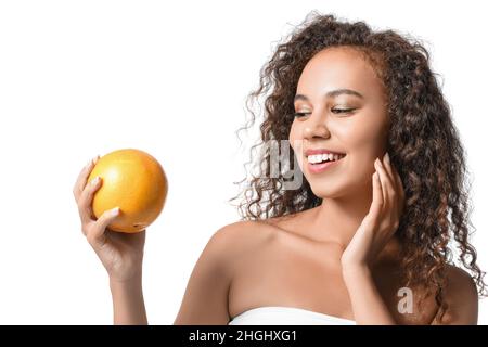 Beautiful African-American woman with grapefruit on white background Stock Photo