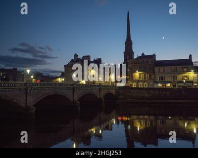 View looking across the river to Ayr Town Hall at a winters dusk with both the Moon and Venus visible. Stock Photo