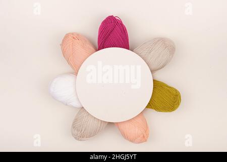 Colored balls of yarn is beige, burgundy, light pink and white. Stock Photo
