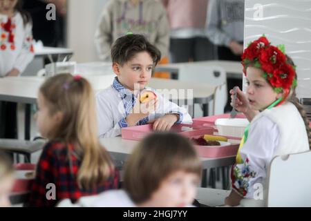 KYIV, UKRAINE - JANUARY 21, 2022 - Students have dinner in the canteen of N209 Suziria school, Kyiv, capital of Ukraine. Schools are now introducing t Stock Photo