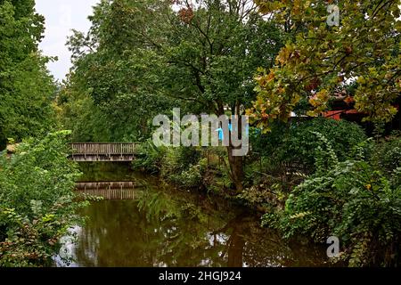 A small wooden bridge crossing the Delaware River Canal with reflections. Taken from Bridge Street in Lambertville NJ by the Restaurant. Near New Hope Stock Photo