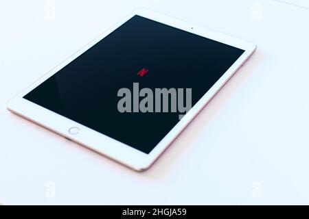 Barcelona, 2022: Tablet with Netflix logo on an empty background. Streaming and technology. Copy space Stock Photo