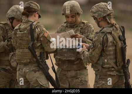 As soldiers of C Company arrived at the starting point they made one last check of their maps and talked about contingency plans.     One of the last and vital training activities for the 145th Brigade Support Battalion during annual training was their introduction into convoy escort and protection. Soldiers began with attending a virtual classroom training situation and then moved to the desert landscape of the Orchard Combat Training Center. On the OCTC, soldiers followed a vehicle route where a variety of different situations occurred to test their reactions and training. Along the convoy r Stock Photo