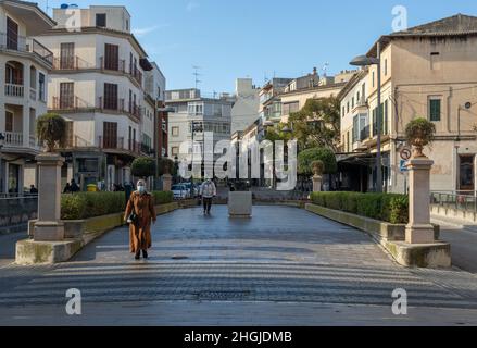 Manacor, Spain; january 20 2022: General view of the Passeig d'Antoni Maura, in the historic center of the Mallorcan town of Manacor. People with mask Stock Photo