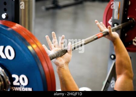A competitor gets ready to perform a bench press at the power lifting ...