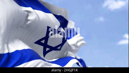 Detail of the national flag of Israel waving in the wind on a clear day. Democracy and politics. Patriotism. Selective focus. Stock Photo