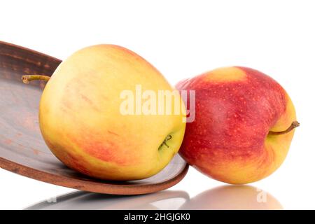 Three red juicy apples on a clay plate, macro, isolated on white. Stock Photo