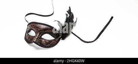 Carnival mask brown color with black feather decoration isolated on white background, design element Stock Photo