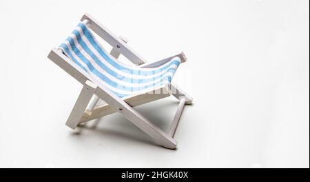 Deck chair, white blue striped beach chair isolated on white background. Summer holiday by the sea Stock Photo