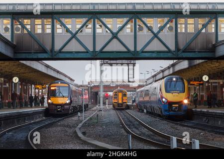 Crosscountry trains, Northern Rail, East Midlands railway trains connecting at Nottingham railway station with analogue railway station clocks. Stock Photo