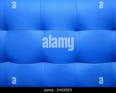 Detailed background of soft furniture leather or leatherette surface. Square stitching pattern. Stock Photo