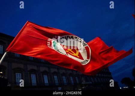 Naples, Italy. 21st Jan, 2022. Communist Party flag placed in Piazza Plebiscito in Naples with the words 'We will not pay the costs of the Pandemic, health is not a privilege' during the demonstration by citizens for the new coronavirus laws. Credit: Vincenzo Izzo/Alamy Live News Credit: Vincenzo Izzo/Alamy Live News Stock Photo
