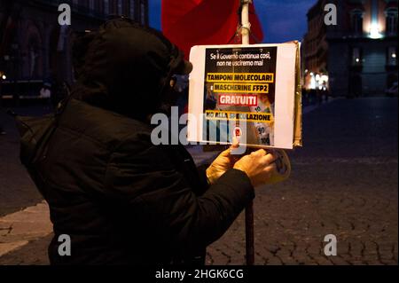 Naples, Italy. 21st Jan, 2022. Protester in Piazza Plebiscito in Naples with the words 'We will not pay the costs of the Pandemic, health is not a privilege' during the demonstration by citizens for the new coronavirus laws. Credit: Vincenzo Izzo/Alamy Live News Credit: Vincenzo Izzo/Alamy Live News Stock Photo