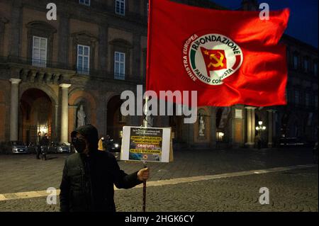 Naples, Italy. 21st Jan, 2022. Protester holds the flag for the communist party in plebiscite square during the demonstration by citizens for the new coronavirus laws. Credit: Vincenzo Izzo/Alamy Live News Credit: Vincenzo Izzo/Alamy Live News Stock Photo