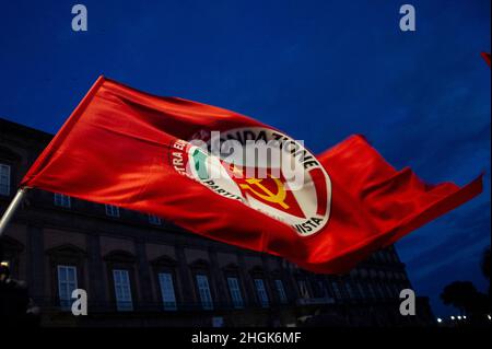 Napoli, Italy. 21st Jan, 2022. Communist Party flag placed in Piazza Plebiscito in Naples with the words 'We will not pay the costs of the Pandemic, health is not a privilege' during the demonstration by citizens for the new coronavirus laws. Napoli, Italy, 21 January 2022. (photo by Vincenzo Izzo/Sipa USA) Credit: Sipa USA/Alamy Live News Stock Photo