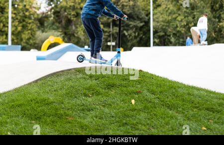 child going airborne with his scooter Stock Photo