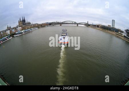 Cologne, Germany - December 24, 2021: a tanker sails on the rhine through the old town of cologne