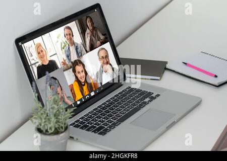 Teacher Hosting Online Class Using Video Conference On Laptop Stock Photo