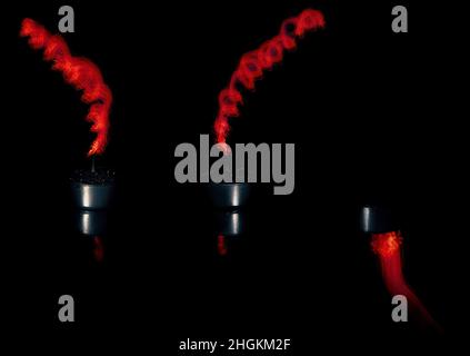 Three candles light painted with one showing the surface reflection only Stock Photo