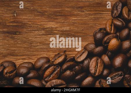 Coffee beans roasted on wooden background Close up macro copy space Stock Photo