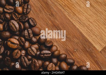 Coffee beans roasted on wooden background Close up macro copy space Stock Photo