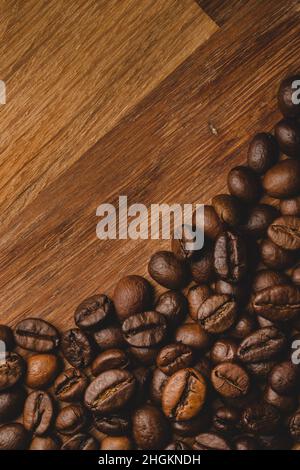 Coffee beans roasted on wooden background Close up macro copy space Stock Photo