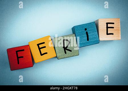Colorful wooden blocks for children with the words 'Ferie' in Polish, which means a winter break in school for schools in Poland Stock Photo
